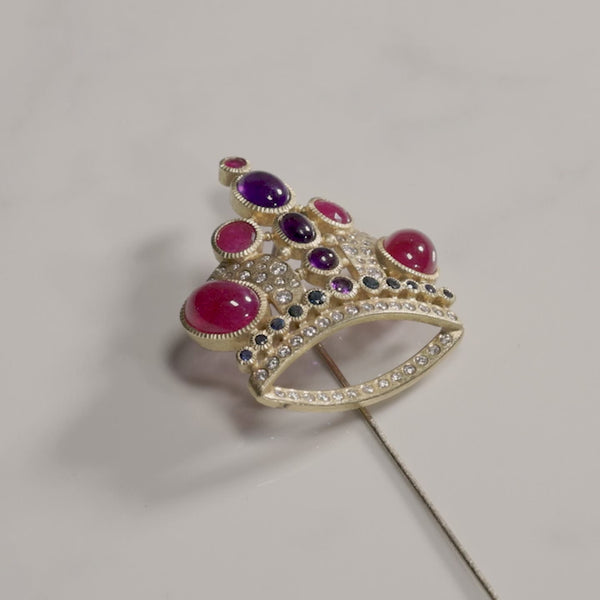 Todd Reed pin made with 18k yellow gold, white brilliant cut diamonds (.73ct), amethysts (2.19ct), rubies (10.28ct) and sapphires (.47ct)