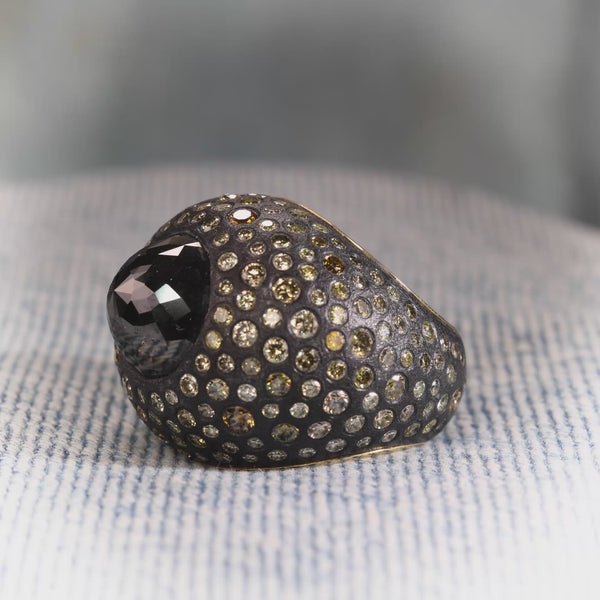 Todd Reed ring with a black rose cut diamond (10.75ctw) and olive diamonds (5.88ctw) in 18k yellow gold and sterling silver.